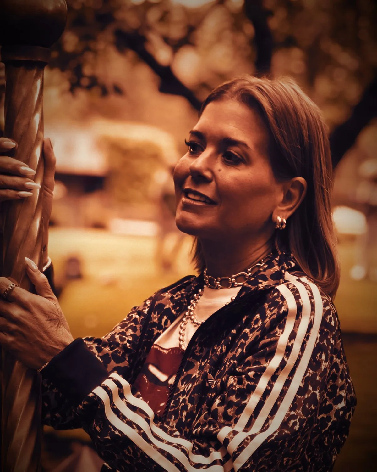 Cortnie Kairos looking up, mid-laugh, in warm light
