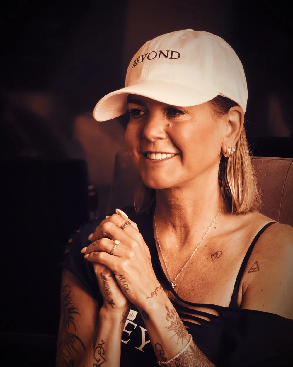Cortnie Kairos, hands clasped, listening