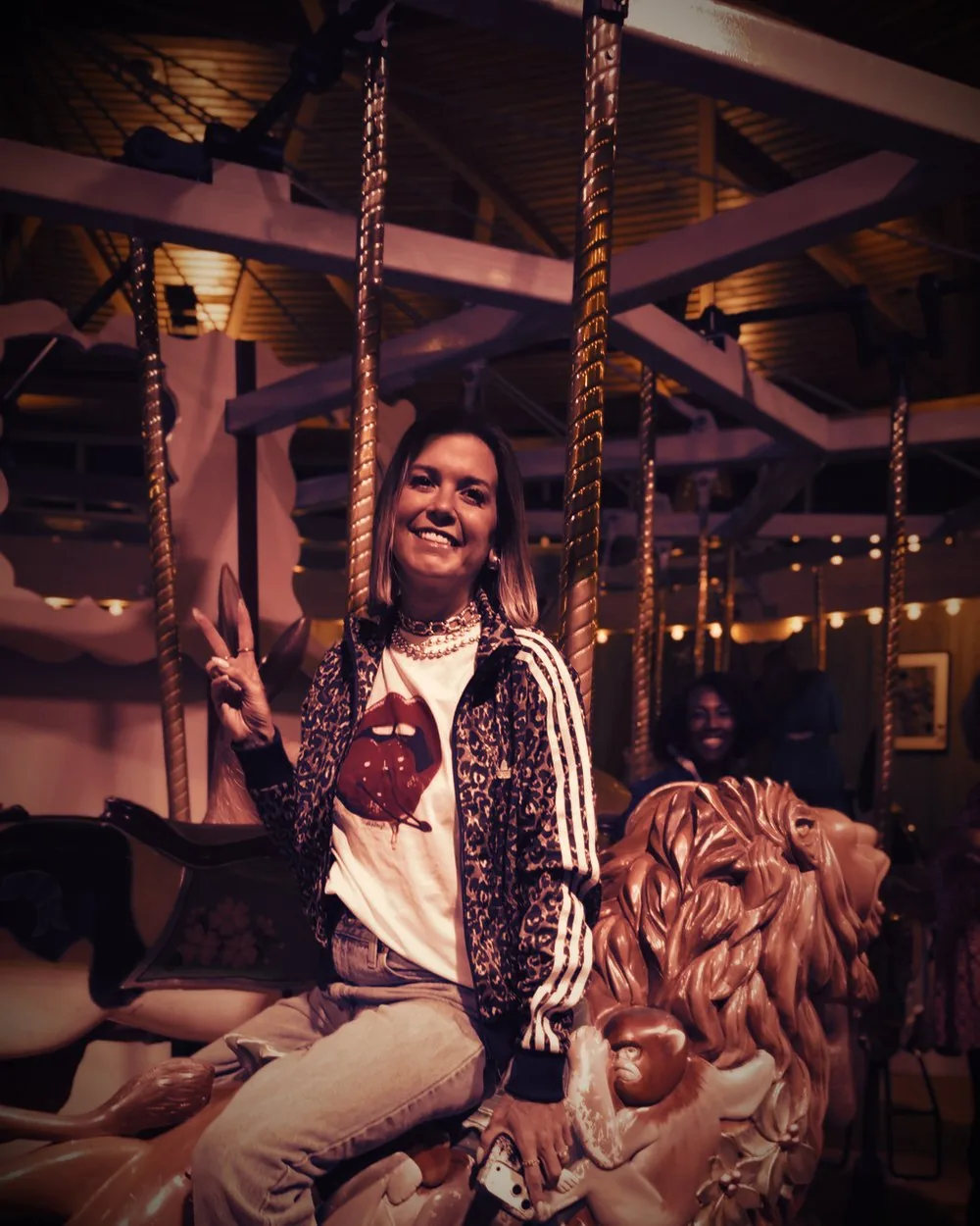 Cortnie Kairos on a carousel, laughing